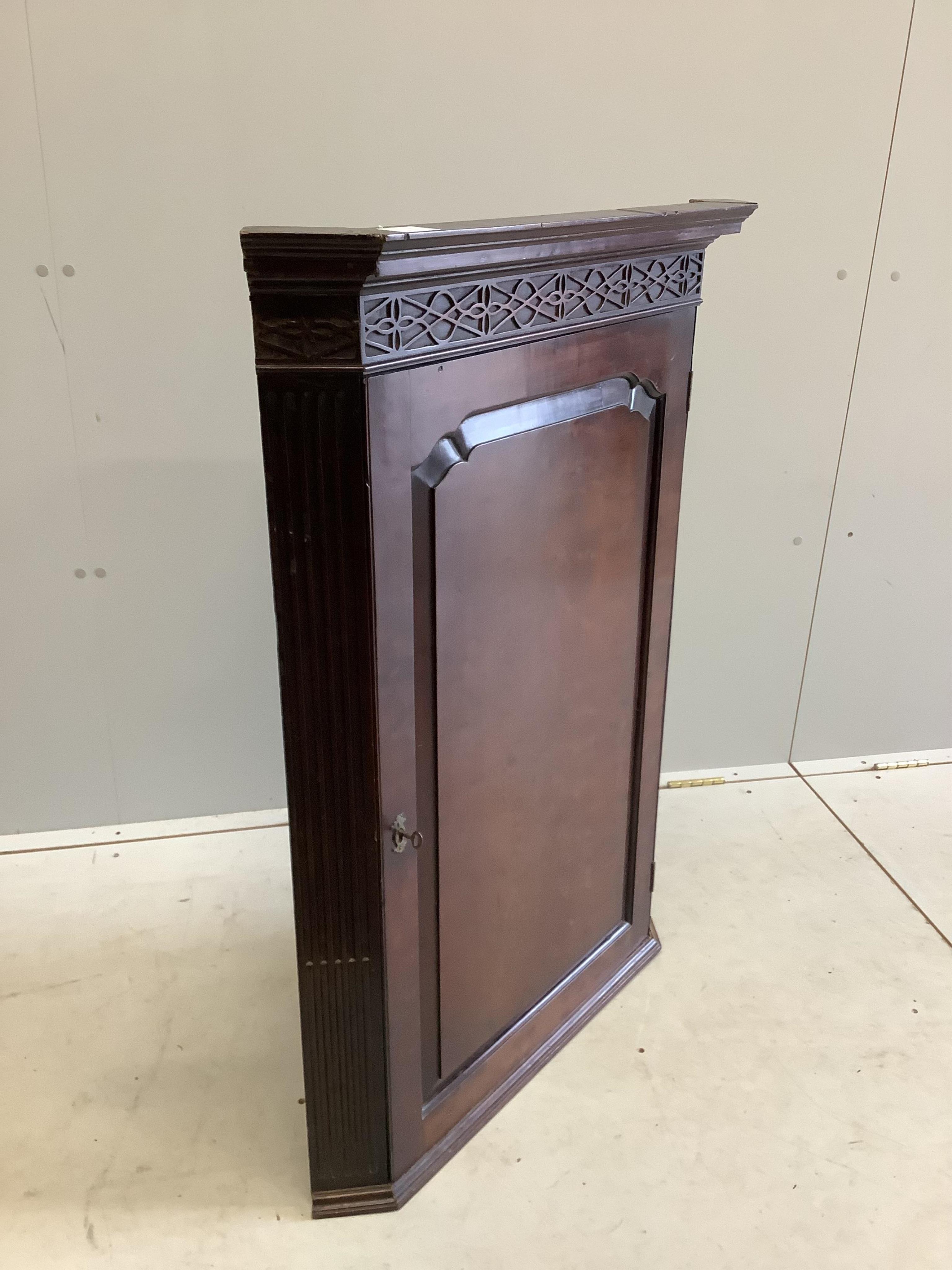 A George III Chippendale style mahogany hanging corner cabinet, width 75cm, depth 41cm, height 102cm. Condition - fair to good